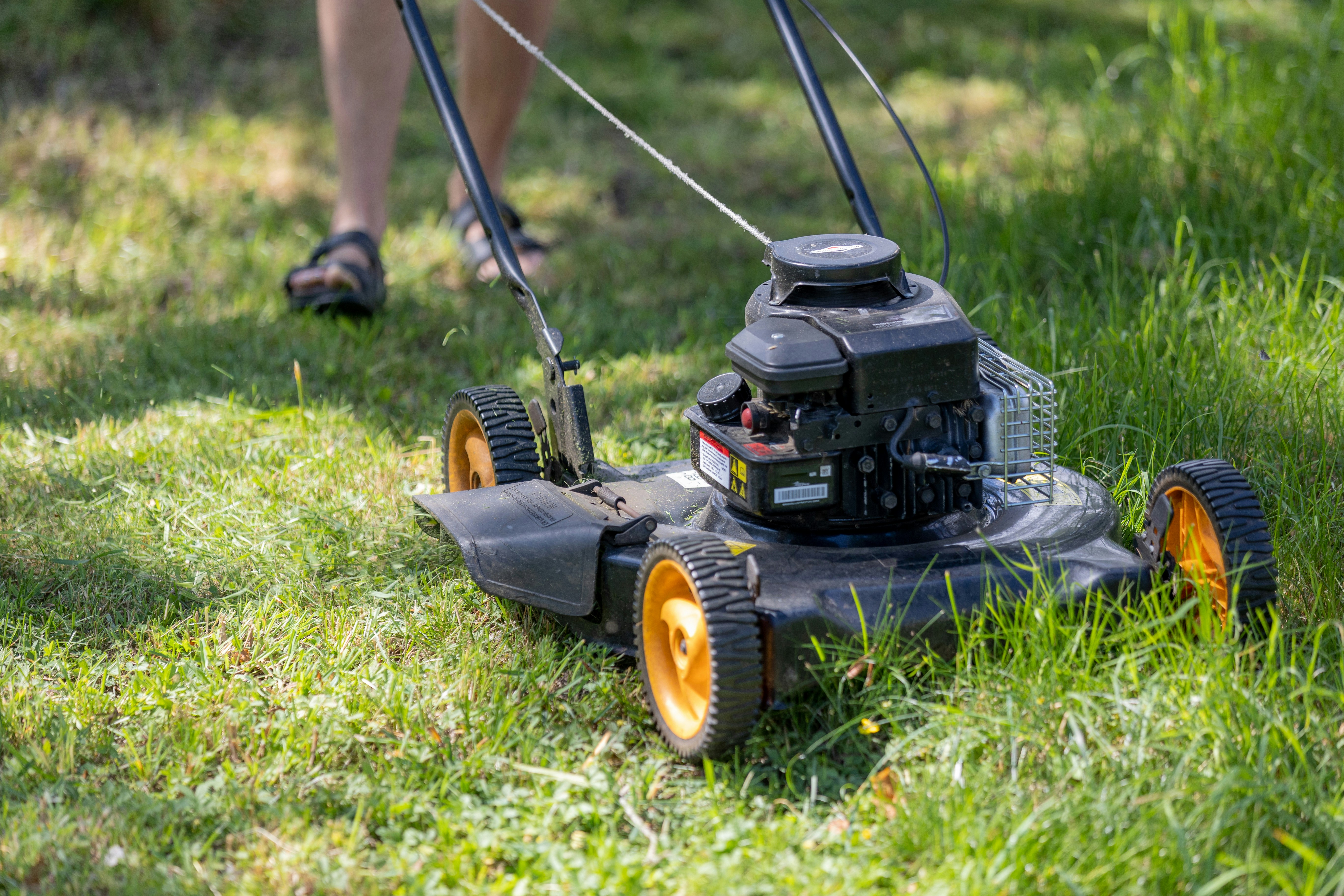 Lawn mower cutting grass in the Winchester Lawn Demo site